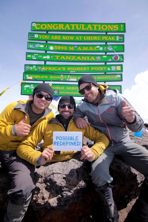 Spencer (centre) with Alex (left) and David at the summit of Mt. Kilimanjaro. They were able to raise well over their goal of half a million dollars and provide funding for clean water to 12,500 people for life in East Africa.